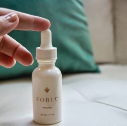 white plastic bottle on white textile