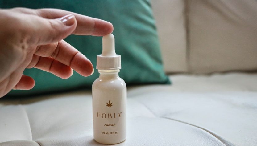 white plastic bottle on white textile