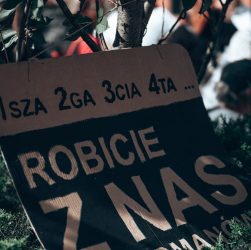 a sign in front of a crowd